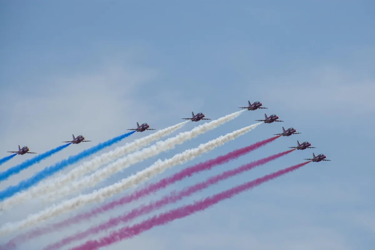 Aviões sobrevoando e deixando fumaça colorida no ar